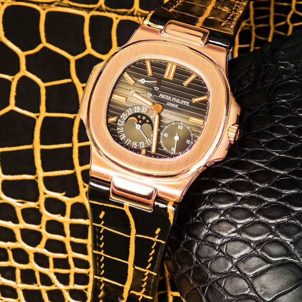 black-gold-alligator-leather-watch-strap-for-Patek-Philippe-Nautilus-5712r-on-watch.png