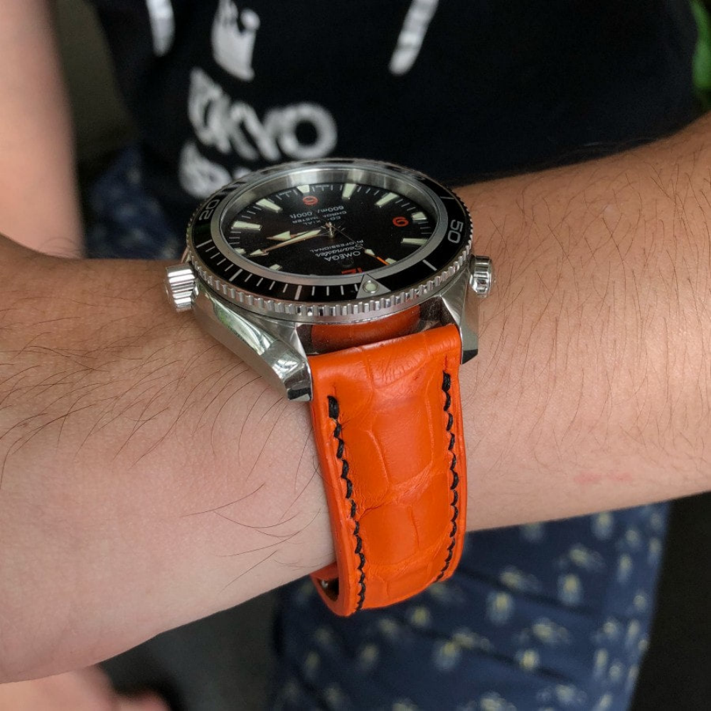 orange-alligator-strap-for-omega-seamaster-on-hand.png